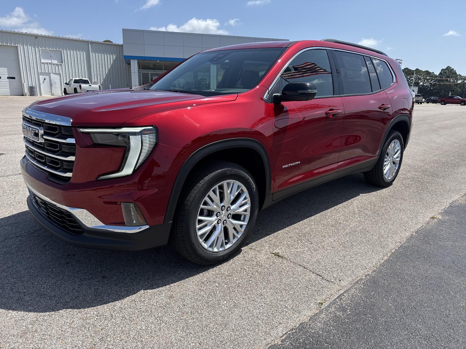 2026 GMC Acadia Elevation in Volcanic Red Tintcoat — front three-quarter view